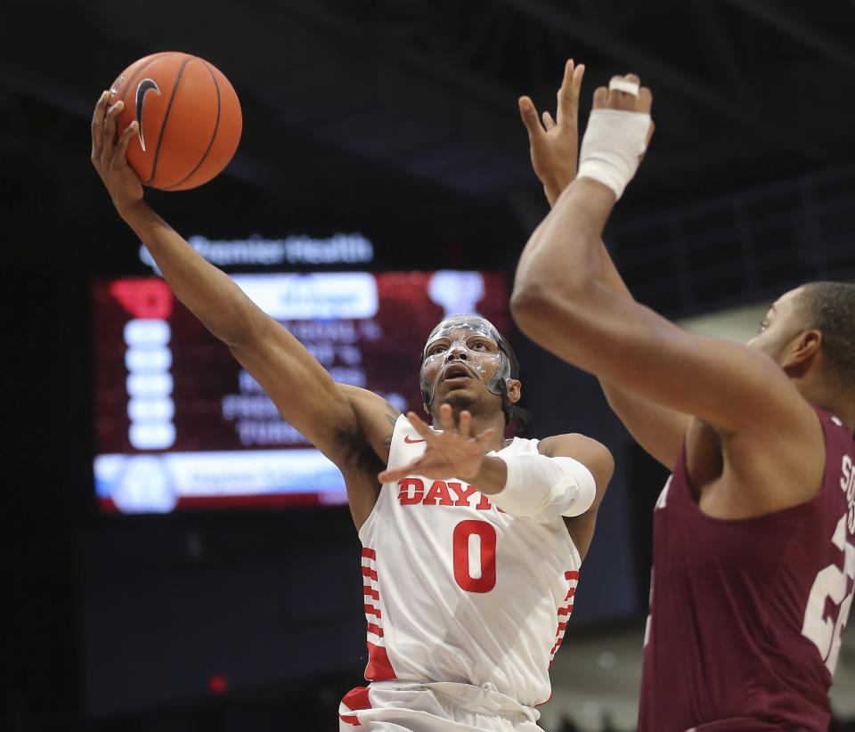 Dayton's Rodney Chatman (0) drives to the basket against Fordham's Joel Soriano (22) during the first half of an NCAA college basketball game Saturday, Feb. 1, 2020, in Dayton , Ohio. (AP Photo/Tony Tribble)