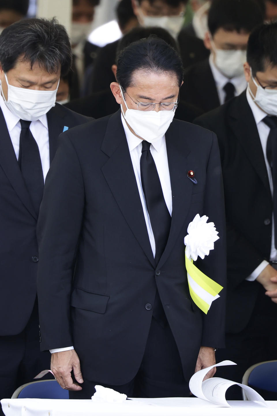 Japanese Prime Minister Fumio Kishida offers silent prayers at the 77th anniversary of the Nagasaki atomic bombing in Nagasaki, southern Japan, Tuesday, Aug. 9, 2022. (Kyodo News via AP)