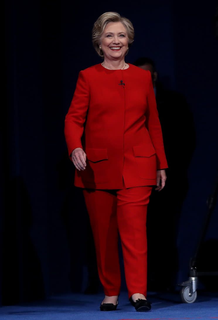 Hillary Clinton strides onstage for her first presidential debate with Donald Trump in a bright-red suit by Ralph Lauren. (Photo: Getty)