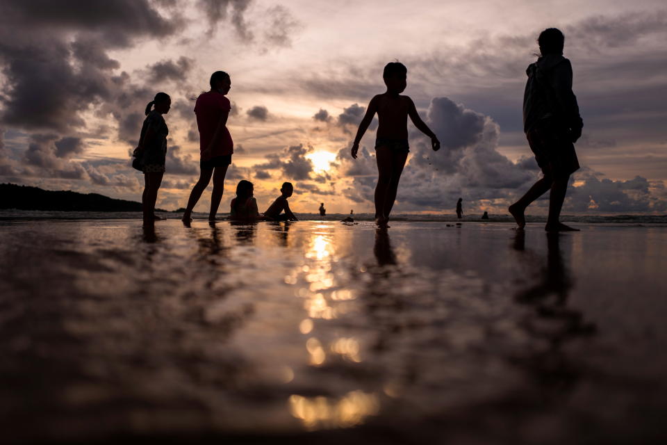 People enjoy at a beach as Phuket opens for foreigners, who are fully vaccinated against the coronavirus disease (COVID-19), to visit the resort island without quarantine, in Phuket, Thailand, September 19, 2021. REUTERS/Athit Perawongmetha     TPX IMAGES OF THE DAY