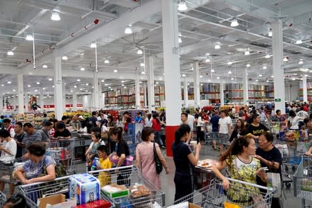 People visit a U.S. hypermarket chain Costco Wholesale Corp store in Shanghai