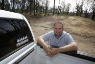 In this Thursday, Oct. 24, 2019, photo, Paradise City Councilman Michael Zuccolillo poses at the lot where his home once stood before it was destroyed by last year's Camp Fire in Paradise, Calif. Zuccolillo's home is one of nearly 9,000 Paradise homes destroyed in the deadliest and most destructive wildfire in California history. (AP Photo/Rich Pedroncelli)