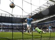 Manchester City's Edin Dzeko (L) scores a goal during their English Premier League soccer match against Southampton at the Etihad stadium in Manchester, northern England April 5, 2014. REUTERS/Darren Staples