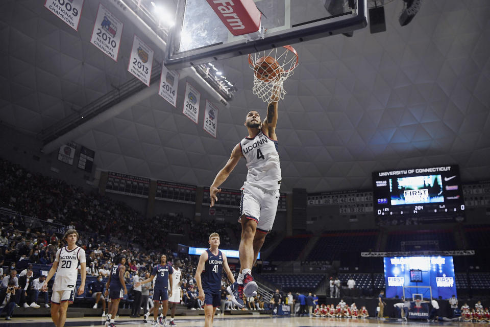 Connecticut's Tyrese Martin dunks during First Night events for the UConn men's and women's NCAA college basketball teams Friday, Oct. 15, 2021, in Storrs, Conn. (AP Photo/Jessica Hill)