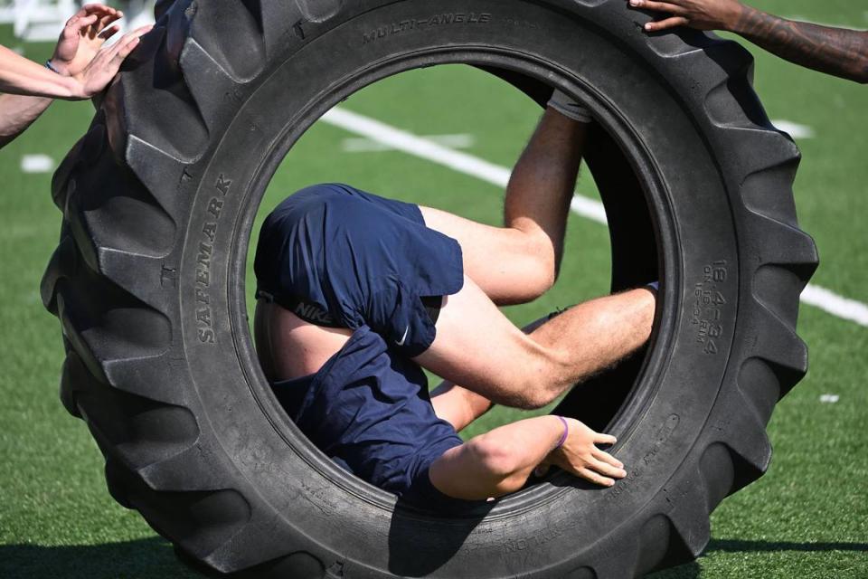 A Penn State football player is rolled down the field in tractor tire during the Nittany Lions annual Lift For Life event at University Park Thursday, June 30, 2022.