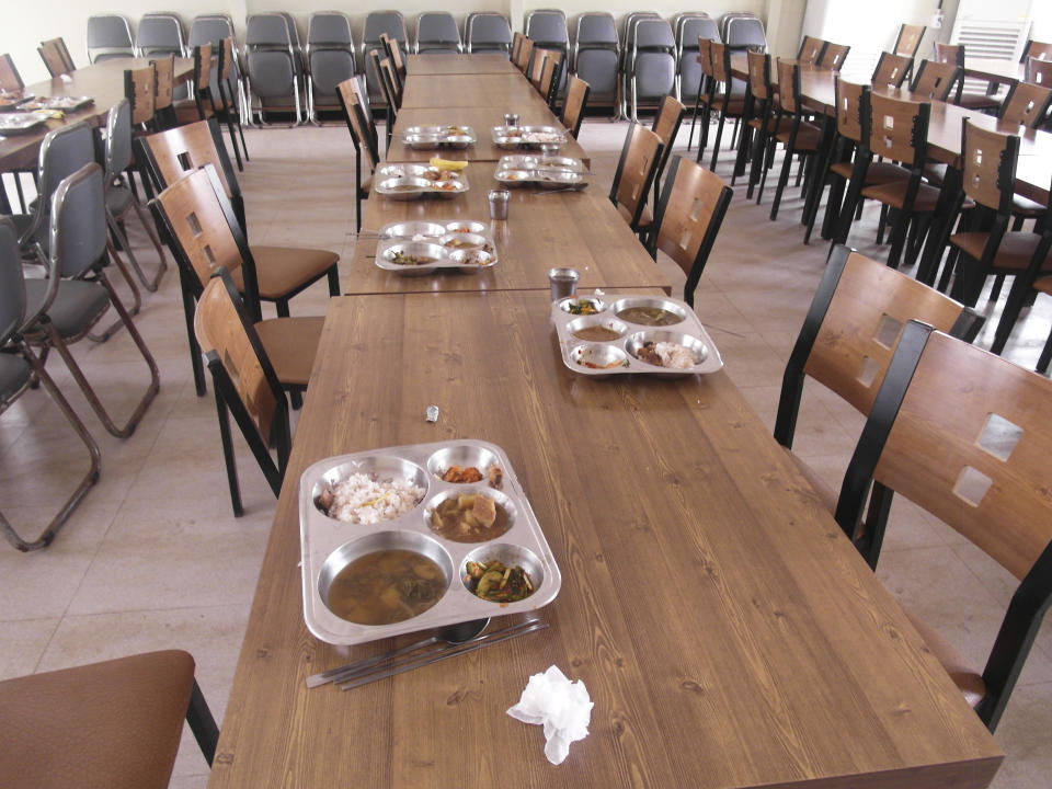 Lunch trays for students are left on tables of a cafeteria after students were evacuated to a shelter at a school on Yeonpyeong island, South Korea, near the West Sea border with North Korea, Monday, March 31, 2014. North and South Korea fired artillery shells into each other's waters Monday, a flare-up of animosity between the rivals that forced residents of five front-line South Korean islands to evacuate to shelters, South Korean officials said. (AP Photo) KOREA OUT