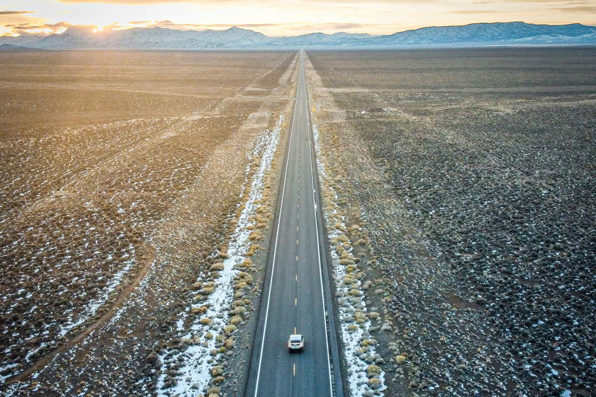 lone car driving along the The Loneliest Road in America