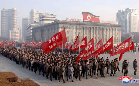 North Korean government officers mark a labour workday - Credit: KCNA via Reuters