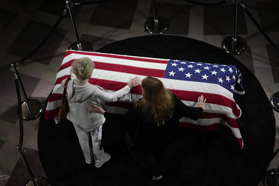 Lynne Kennedy, left, sister of U.S. Sen. Dianne Feinstein, places her hand on Feinstein's casket at City Hall Wednesday, Oct. 4, 2023, in San Francisco. Feinstein, who died Sept. 29, served as San Francisco's mayor. (AP Photo/Godofredo A. Vásquez)