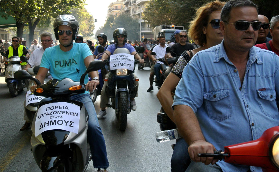 Municipal workers drive their motorcycles during a protest against the new austerity measures in the northern port city of Thessaloniki, Greece, on Wednesday, Oct. 3, 2012. Greece's brutal recession is set to extend into a sixth year in 2013, when the economy will contract by another 3.8 percent, according to forecasts in the draft budget submitted to Parliament. Unemployment is predicted to rise to 24.7 percent in 2013 from an average 23.5 percent in 2012. The budget sees Greece's government still running at a loss despite waves of spending cuts and tax hikes over the past two years, as it has struggled to meet the terms for rescue loans from other eurozone countries and the International Monetary Fund. Banner reads: reads "protest of municipality workers". (AP Photo/Nikola Giakoumidis)
