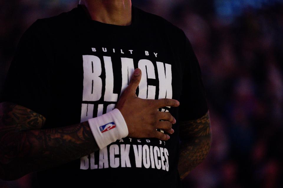 Utah Jazz forward John Collins (20) puts his hand over his heart while wearing the NBA shirt for Black History Month that reads “Built by black history elevated by black voices” before the NBA basketball game between the Utah Jazz and the Golden State Warriors at the Delta Center in Salt Lake City on Thursday, Feb. 15, 2024. | Megan Nielsen, Deseret News