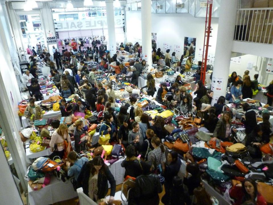 This 2012 photo provided by 260SampleSale shows shoppers looking through designer merchandise at a sample sale at the company’s 260 Fifth Avenue showroom in New York. Sample sales offer leftover designer goods at deep discounts and are sold at a variety of venues around the city, including showrooms like this one. 260SampleSale partners with various designers throughout the year. (AP Photo/ 260SampleSale)