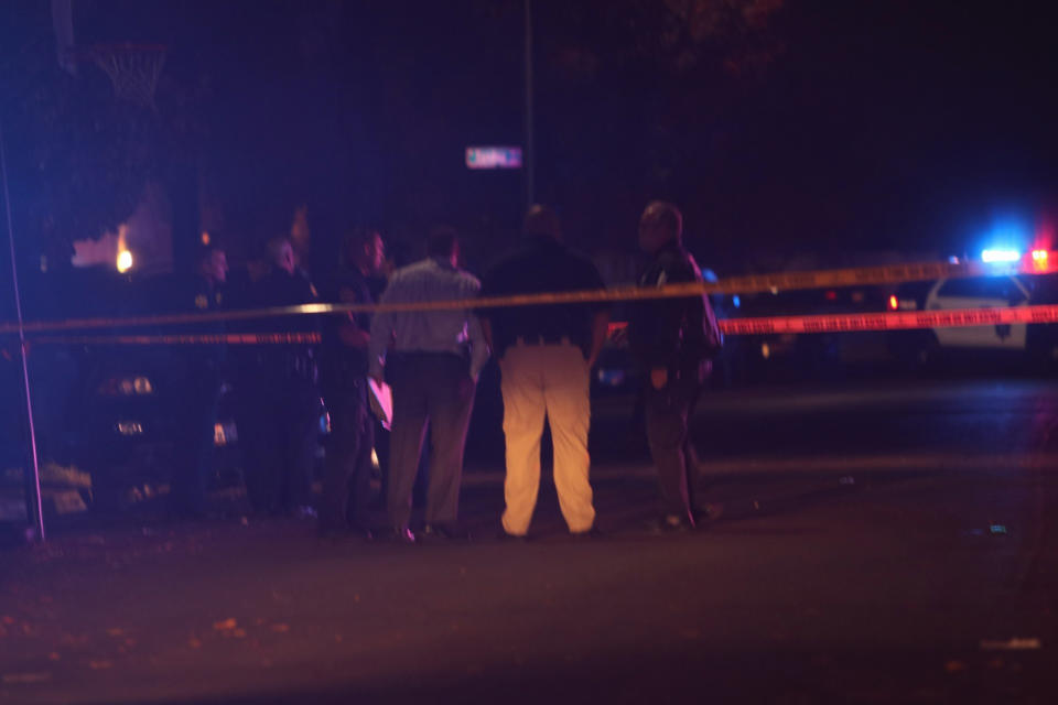 Police and other authorities work at the scene of a shooting at a backyard party, Sunday, Nov. 17, 2019, in southeast Fresno, Calif. (Photo: Larry Valenzuela/The Fresno Bee via AP)