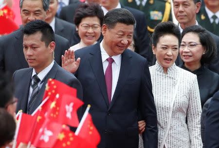 Chinese President Xi Jinping and his wife Peng Liyuan arrive at the airport in Hong Kong, China, ahead of celebrations marking the city's handover from British to Chinese rule, June 29, 2017. REUTERS/Bobby Yip