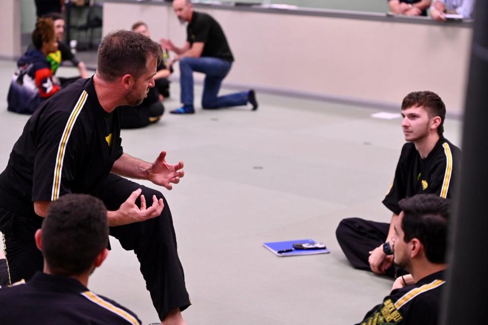 Luke Myers goes over details in a training session with other instructors.