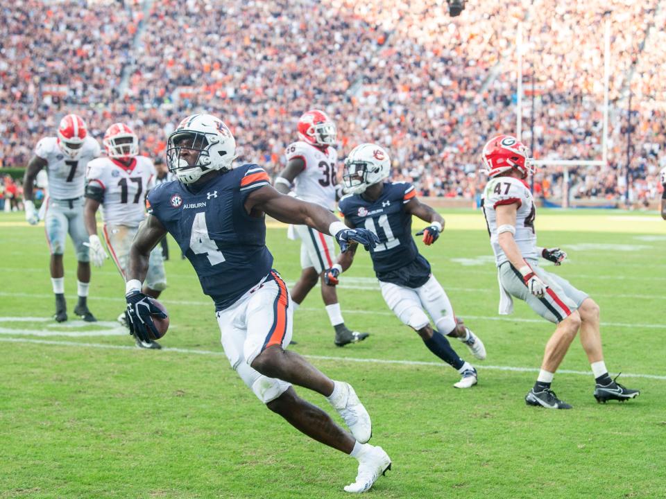 Auburn Tigers running back Tank Bigsby (4) celebrates his touchdown run against Georgia at Jordan-Hare Stadium in Auburn, Ala., on Saturday, Oct. 9, 2021. 