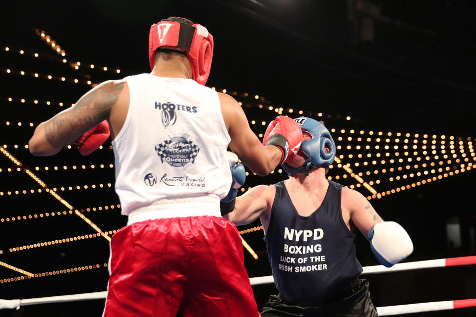 <p>NYPD police officer called “Spiderman” connects with a right on Mike Alba, left, during the NYPD Boxing Championships at the Theater at Madison Square Garden on June 8, 2017. (Photo: Gordon Donovan/Yahoo News) </p>