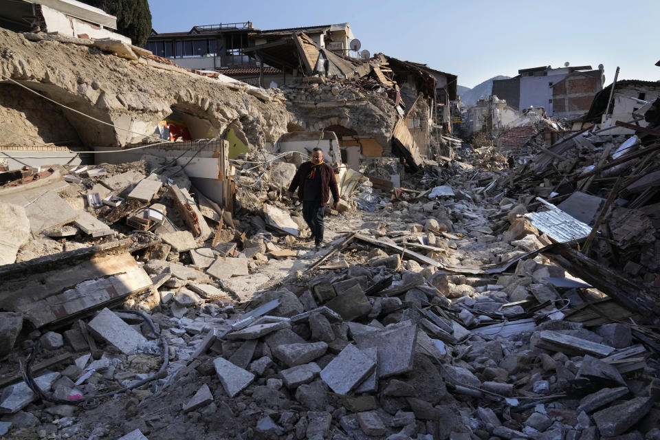 A Turkish man, walks on the debris of the heritage houses that destroyed during the devastated earthquake, in the old city of Antakya, southern Turkey, Monday, Feb. 13, 2023. Antakya, known as Antioch in ancient times, has been destroyed many times by earthquakes. It was destroyed yet again by an earthquake earlier this month, and residents are wondering if its ancient glories will ever come back. (AP Photo/Hussein Malla)