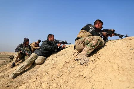 Iraqi security forces snipers aim their weapons towards Mosul's airport during a battle with Islamic State's militants south west Mosul, Iraq February 23, 2017. REUTERS/Zohra Bensemra