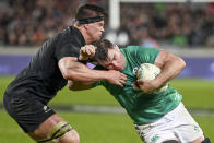 Ireland's Peter O'Mahony runs at New Zealand's Scott Barrett, left, during the rugby international between the All Blacks and Ireland at Eden Park in Auckland, New Zealand, Saturday, July 2, 2022. (Andrew Cornaga/Photosport via AP)