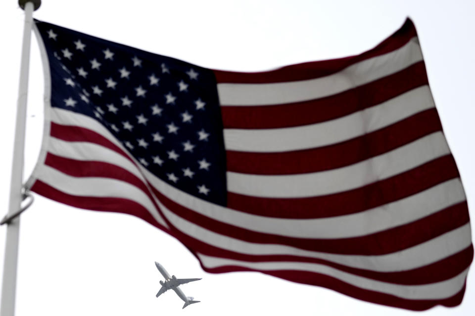 The U.S. flag flaps in the wind as a plane flies over during wreath laying ceremony at NATO headquarters in Brussels, Thursday, April 4, 2024. NATO celebrates on Thursday 75 years of collective defense across Europe and North America as Russia's war on Ukraine enters its third year. (AP Photo/Virginia Mayo)