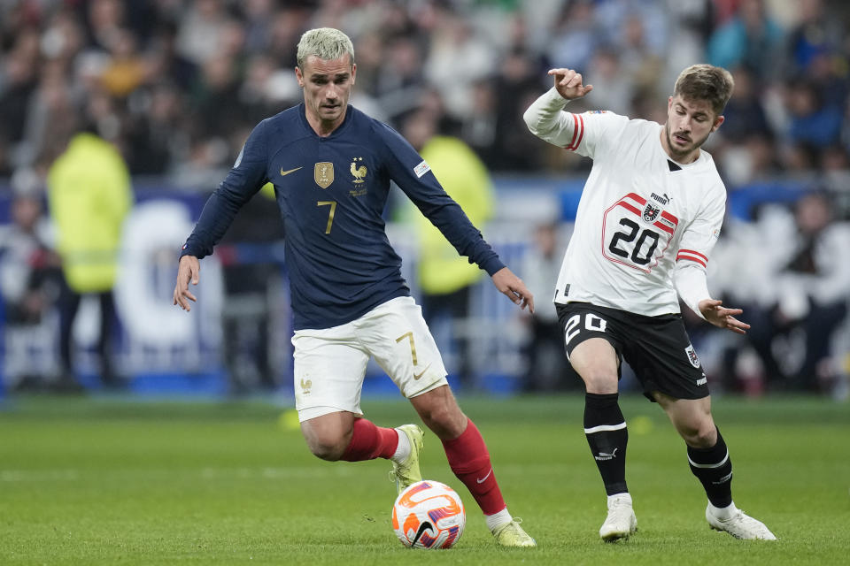 FILE - France's Antoine Griezmann, left, and Austria's Konrad Laimer vie for the ball during the UEFA Nations League soccer match between France and Austria at the Stade de France stadium in Saint Denis, outside Paris, France,Thursday, Sept. 22, 2022. (AP Photo/Christophe Ena, File)