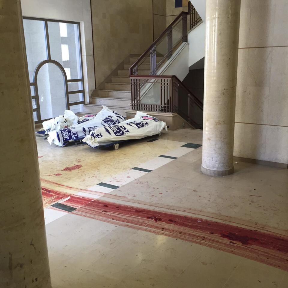 Handout photo of blood trails seen on floor near covered bodies at the scene of an attack in Jerusalem