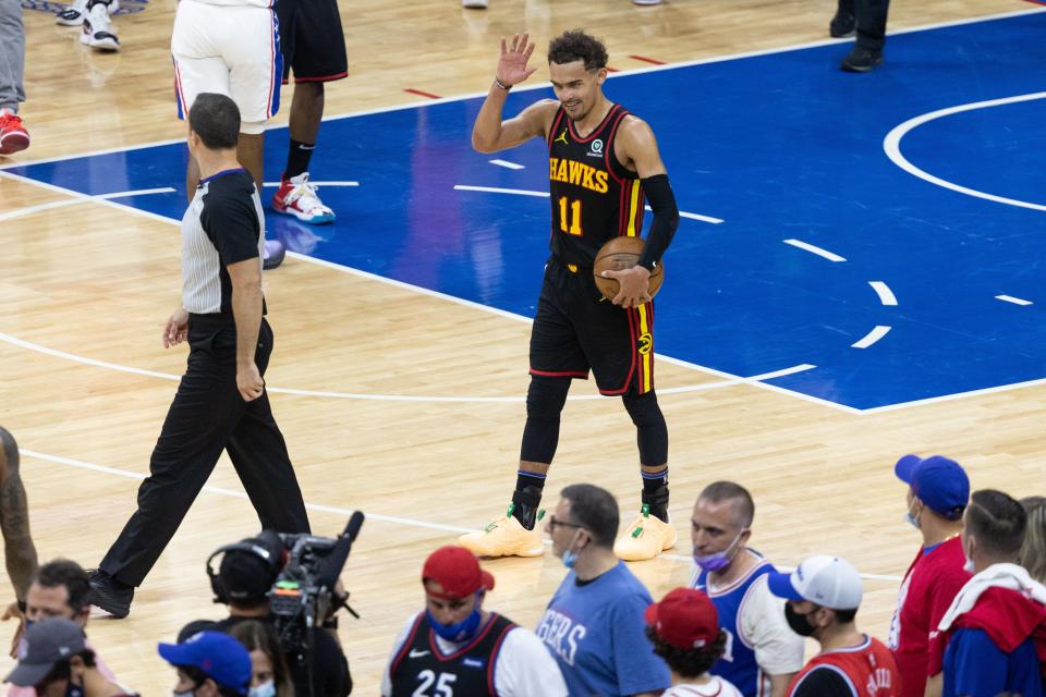 Hawks guard Trae Young reacts waves to the 76ers fans after helping Atlanta advance to the Eastern Conference finals.