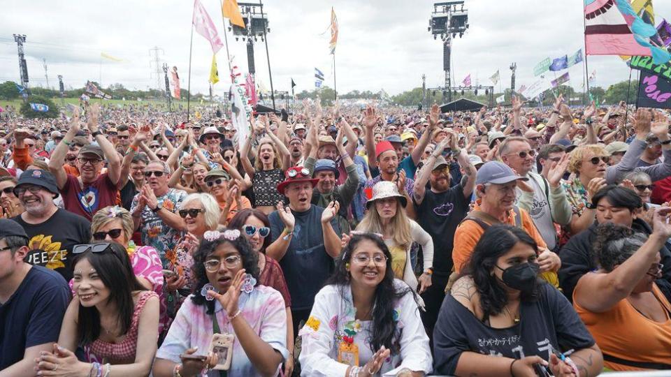 A view across the crowd as Squeeze fans watch and clap