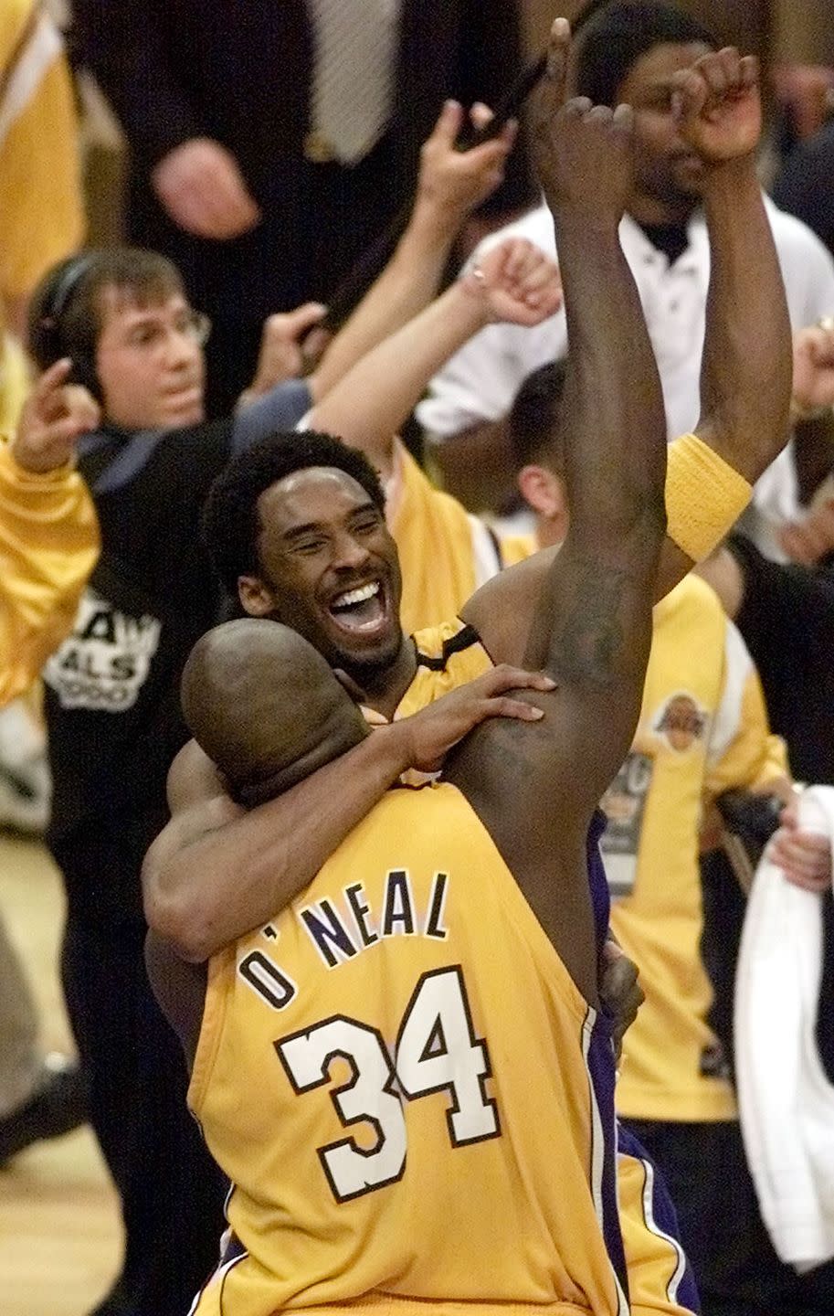 kobe bryant jumps into the arms of shaquille o'nea