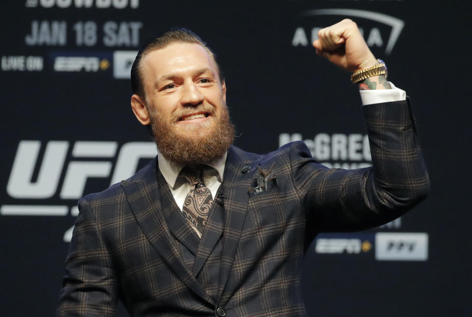 Conor McGregor motions to the crowd during a news conference for a UFC 246 mixed martial arts bout, Wednesday, Jan. 15, 2020, in Las Vegas. McGregor is scheduled to fight Donald "Cowboy" Cerrone in a welterweight bout Saturday. (AP Photo/John Locher)