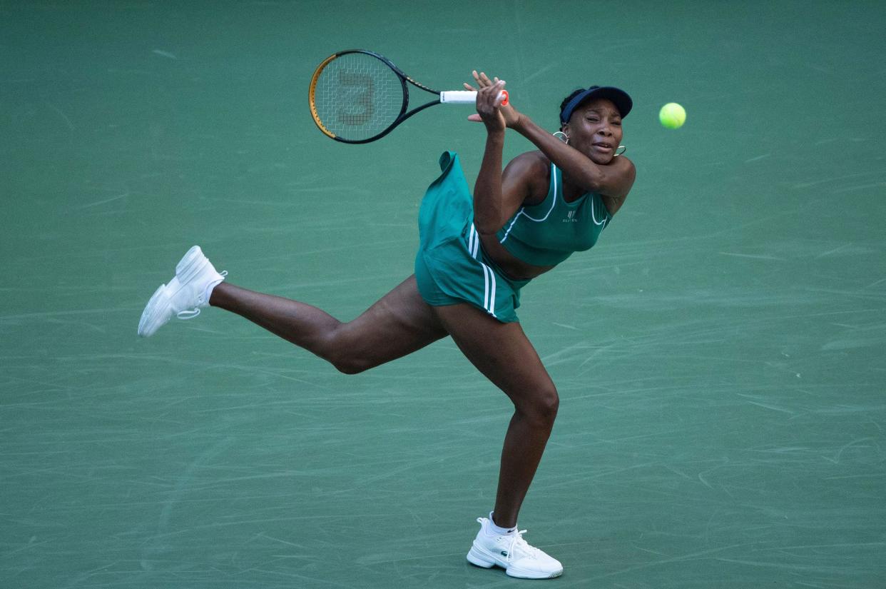 U.S. player Venus Williams hits a return to Belgium's Alison van Uytvanck during their 2022 U.S. Open Tennis tournament women's singles first round match at the USTA Billie Jean King National Tennis Center in New York on Aug. 30, 2022.