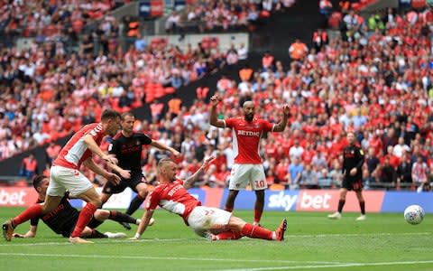 harlton Athletic's Patrick Bauer (centre) scores his side's second goal of the game during the Sky Bet League One Play-off final at Wembley - Credit: Mike Egerton/PA Wire