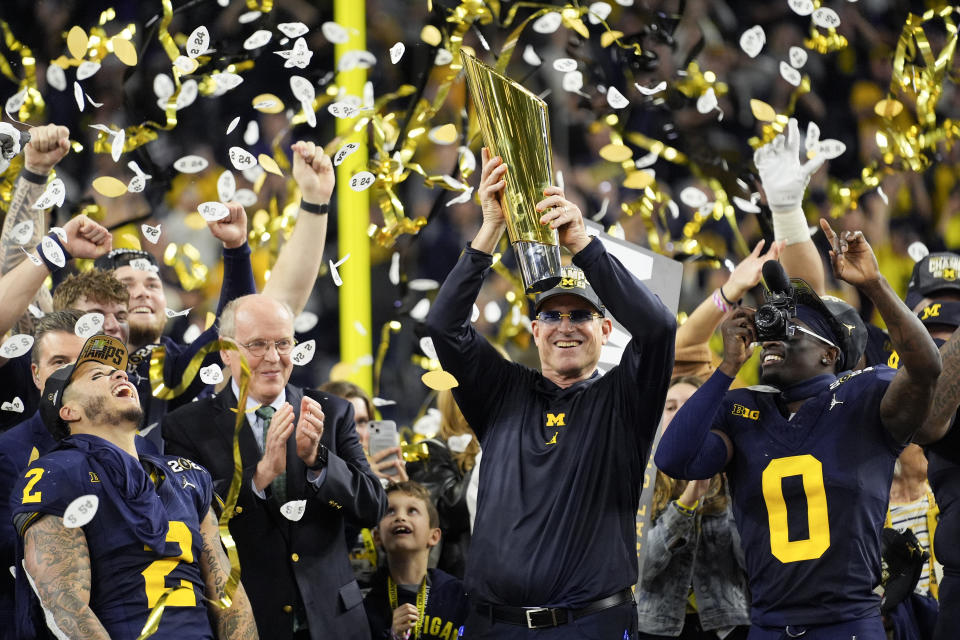 Michigan head coach Jim Harbaugh celebrates with the trophy after their win in the national championship NCAA College Football Playoff game against Washington Monday, Jan. 8, 2024, in Houston. (AP Photo/Eric Gay)