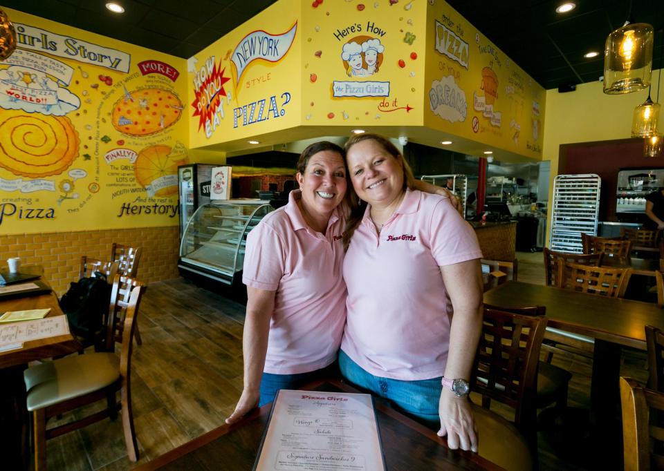 Phoebe Reckseit, left, and Jennifer Morales share a smile at their Pizza Girls restaurant in Palm Beach Gardens in March 2017, when they opened the location.