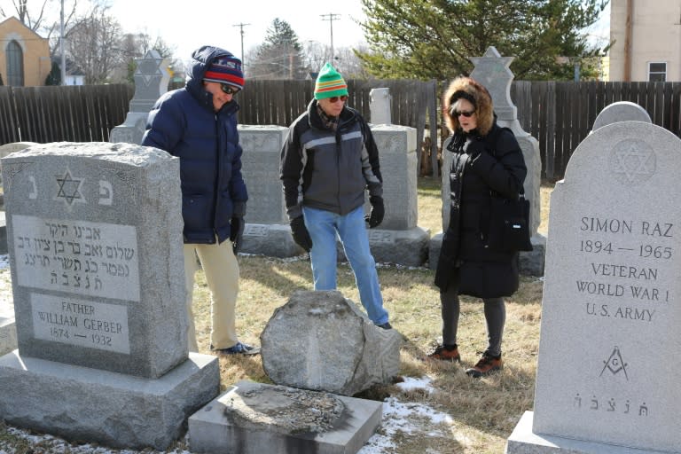 (L-R) Richard Markus, Sidney Markus (C)and Sandy Rosenthal look at a vandalized gravestone at Stone Road or Waad Hakolel Cemetery in Rochester, New York on March 3, 2017