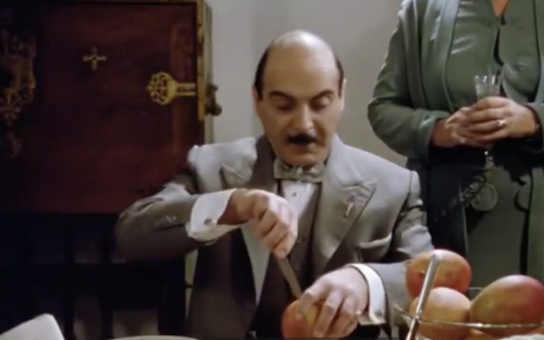 Poirot cutting mango