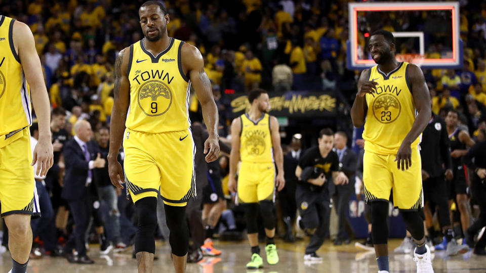 The Warriors walk off the court dejected. (Photo by Ezra Shaw/Getty Images)