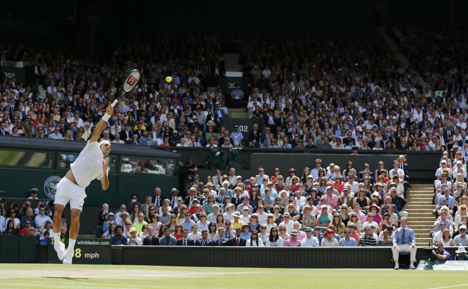 Roger Federer of Switzerland serves during his men's singles final tennis match against Novak Djokovic of Serbia at the Wimbledon Tennis Championships, in London July 6, 2014. REUTERS/Stefan Wermuth