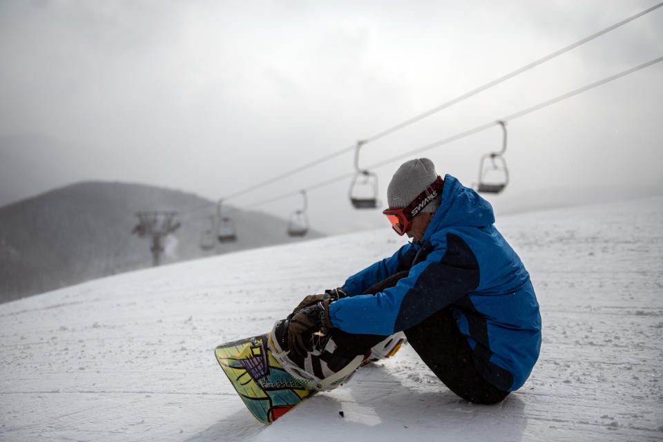 A North Korean man prepares to snowboard from the summit of the 1,360-metre Taehwa Peak at Masikryong Ski Resort on Feb. 5, near Wonsan, North Korea.
