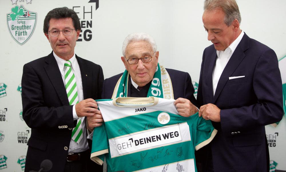 Henry Kissinger is presented with a shirt of the team he supported, Greuther Fürth, in 2012.