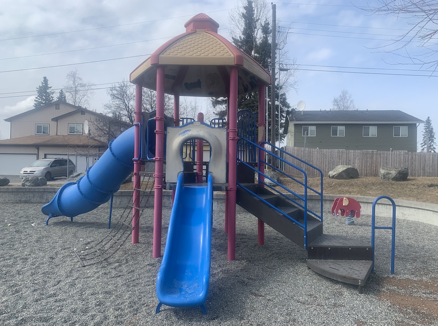 A children's play set sits empty on a cloudy day in Anchorage. Advocates say better access to educational resources might help parents and children engage with their communities. (Photo by Sophia Carlisle/Alaska Beacon)