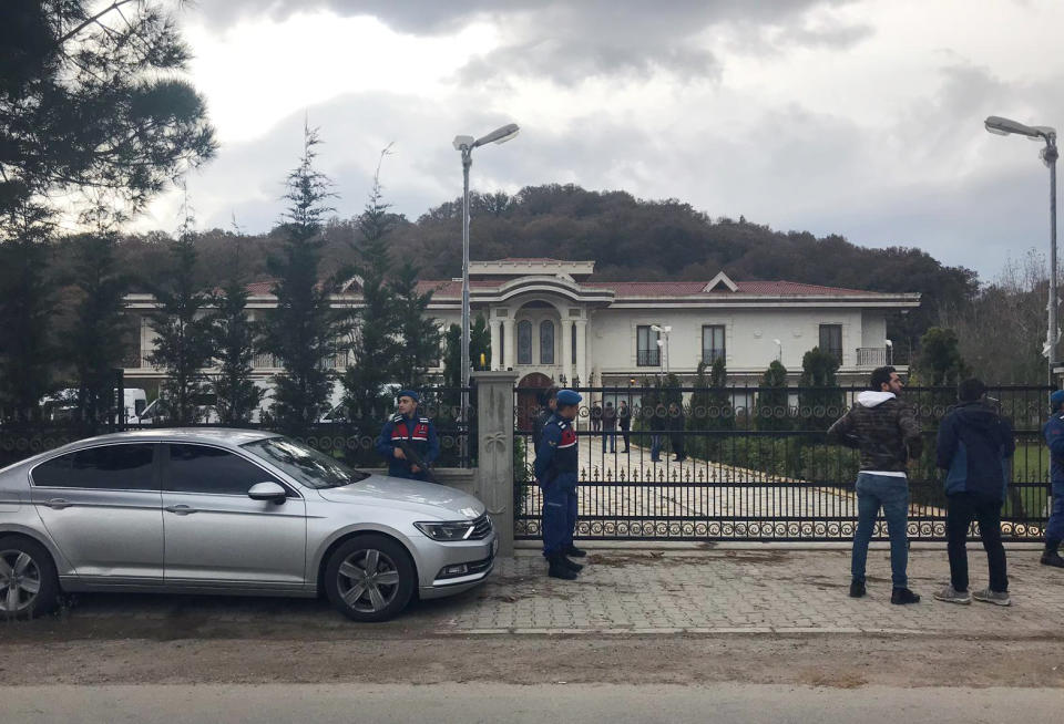 Paramilitary police officers stand at the entrance to a private villa in Yalova, Turkey, Monday, Nov. 26, 2018. Turkey's state-run news agency says police are searching a villa in northwest Turkey as part of an investigation into the killing of Saudi journalist Jamal Khashoggi. (DHA via AP)