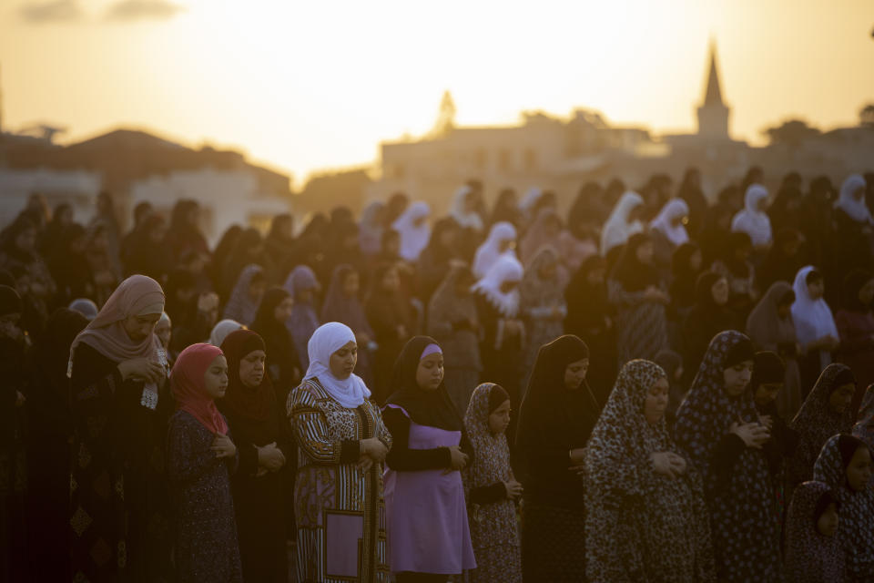 Muslim worshippers offer Eid al-Adha prayer in the mixed Arab Jewish city of Jaffa, near Tel Aviv, Israel, Tuesday, July 20, 2021. The major Muslim holiday, at the end of the hajj pilgrimage to Mecca, is observed around the world by believers and commemorates prophet Abraham's pledge to sacrifice his son as an act of obedience to God. (AP Photo/Oded Balilty)