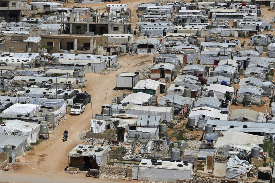 This Sunday, June 16, 2019 photo, shows a Syrian refugee riding a motorcycle among tents at a refugee camp in the eastern Lebanese border town of Arsal, Lebanon. Authorities in Lebanon are waging their most aggressive campaign yet against Syrian refugees, making heated calls for them to go back to their country and taking action to ensure they can’t put down roots. They are shutting down shops where Syrians work without permits and ordering the demolition of anything in their squalid camps that could be a permanent home. (AP Photo/Bilal Hussein)