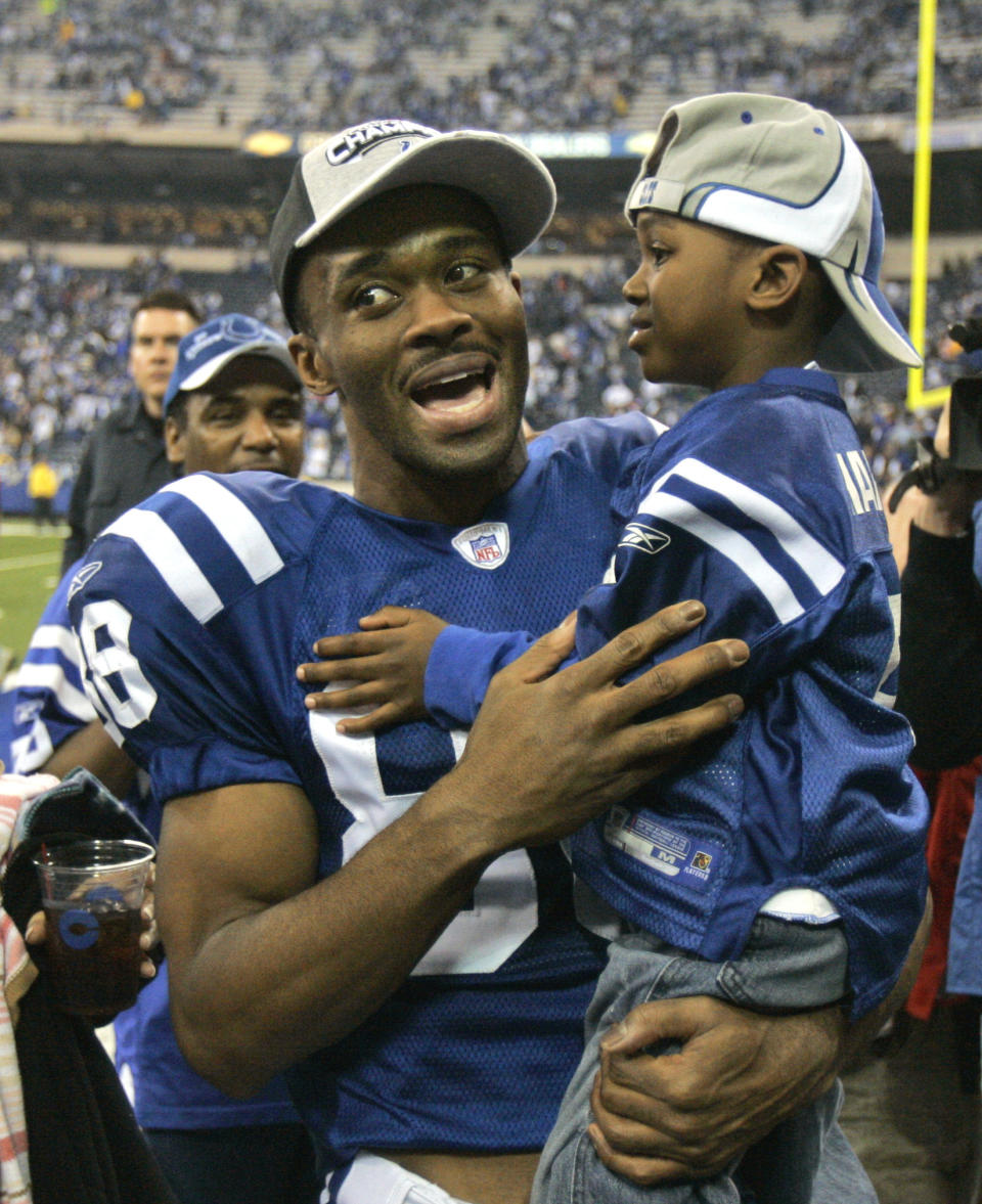 FILE - Indianapolis Colts wide receiver Marvin Harrison holds his son, Marvin Jr., after the Colts beat the New England Patriots, 38-34, to win the AFC Championship football game Sunday, Jan. 21, 2007, in Indianapolis. Harrison Jr., a wide received like his Hall of Fame dad, excelled at Ohio State and is expected to go in the top five at the NFL Draft. (AP Photo/Darron Cummings, File)