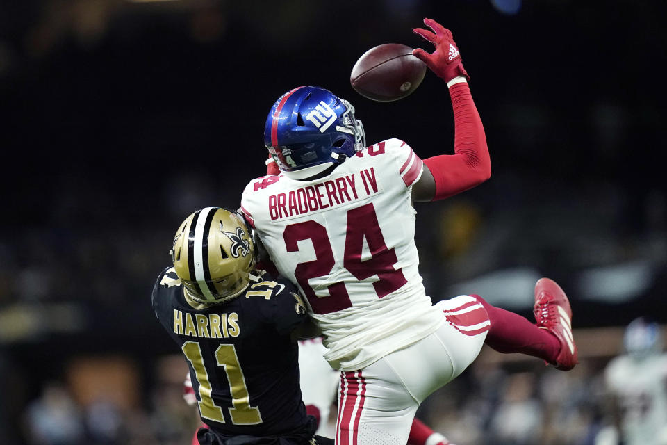 New York Giants cornerback James Bradberry (24) pulls in a pass over New Orleans Saints Deonte Harris (11) in the second half of an NFL football game in New Orleans, Sunday, Oct. 3, 2021. (AP Photo/Brett Duke)