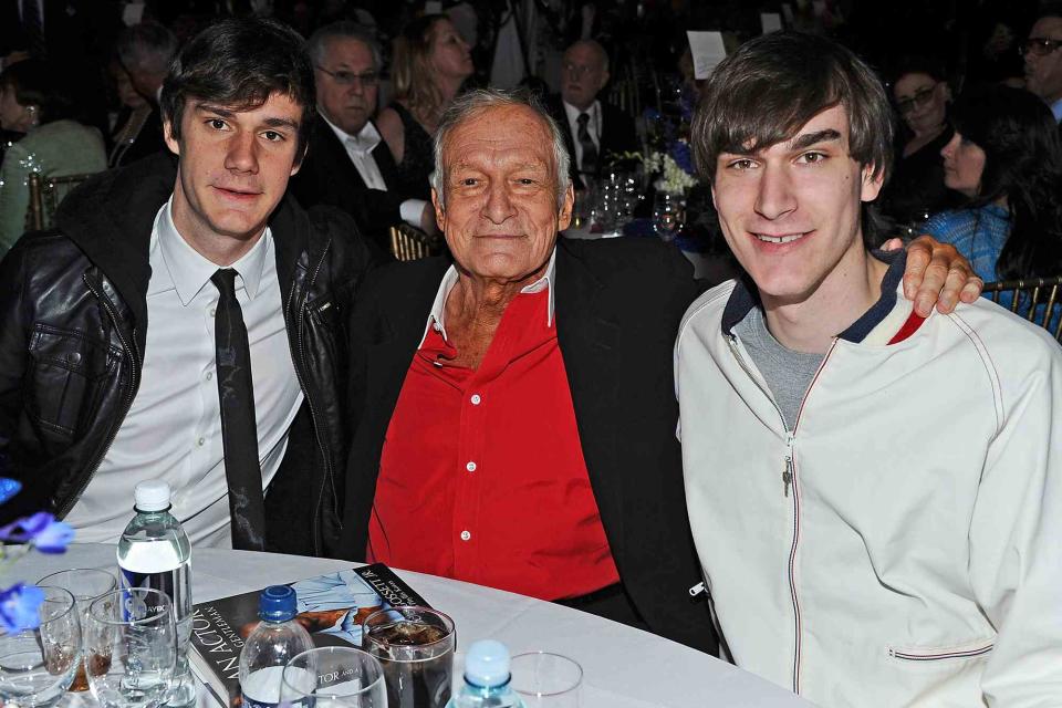 <p>Angela Weiss/Getty</p> Hugh Hefner with his sons Cooper and Marston Hefner in April 2011. 