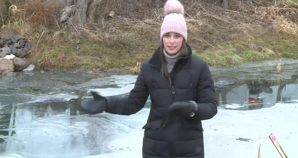 Reporter Phoebe Murray in front of the buttery mess in the canal. (NBC15)