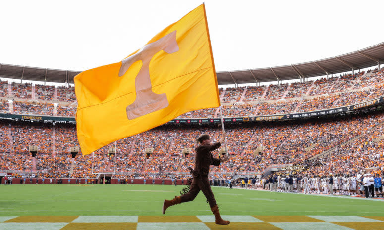 Tennessee's mascot running with a Tennessee flag.